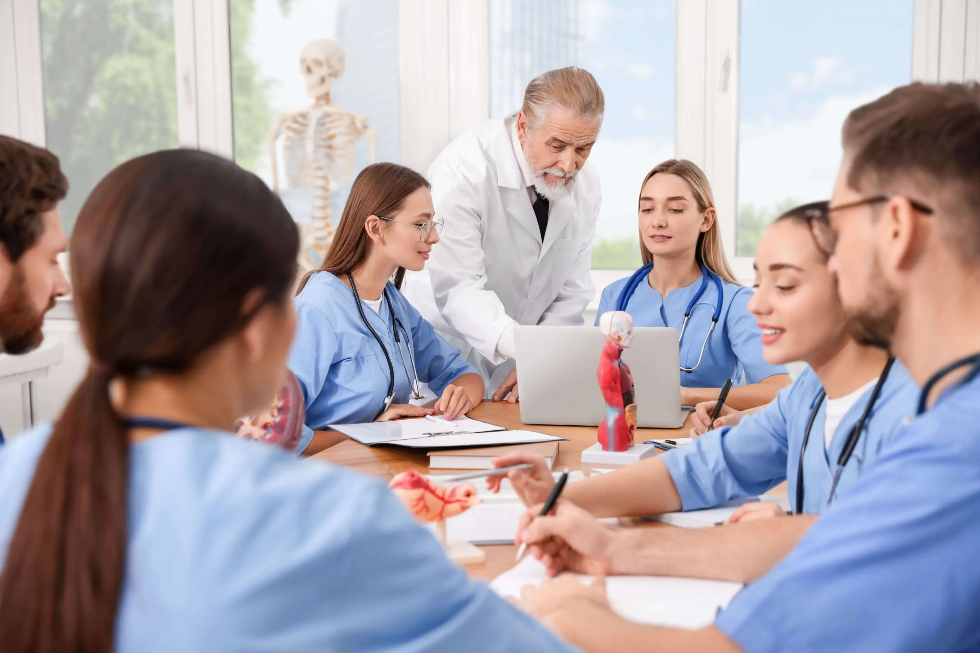 a Medical students learning with a professor.